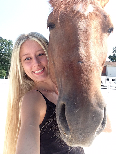 Image of Ashley LeBeau an experienced groomer and her horse.